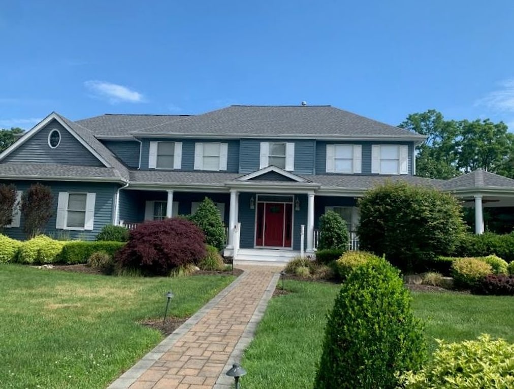 Colonial exterior repainted deep blue-grey with white trim